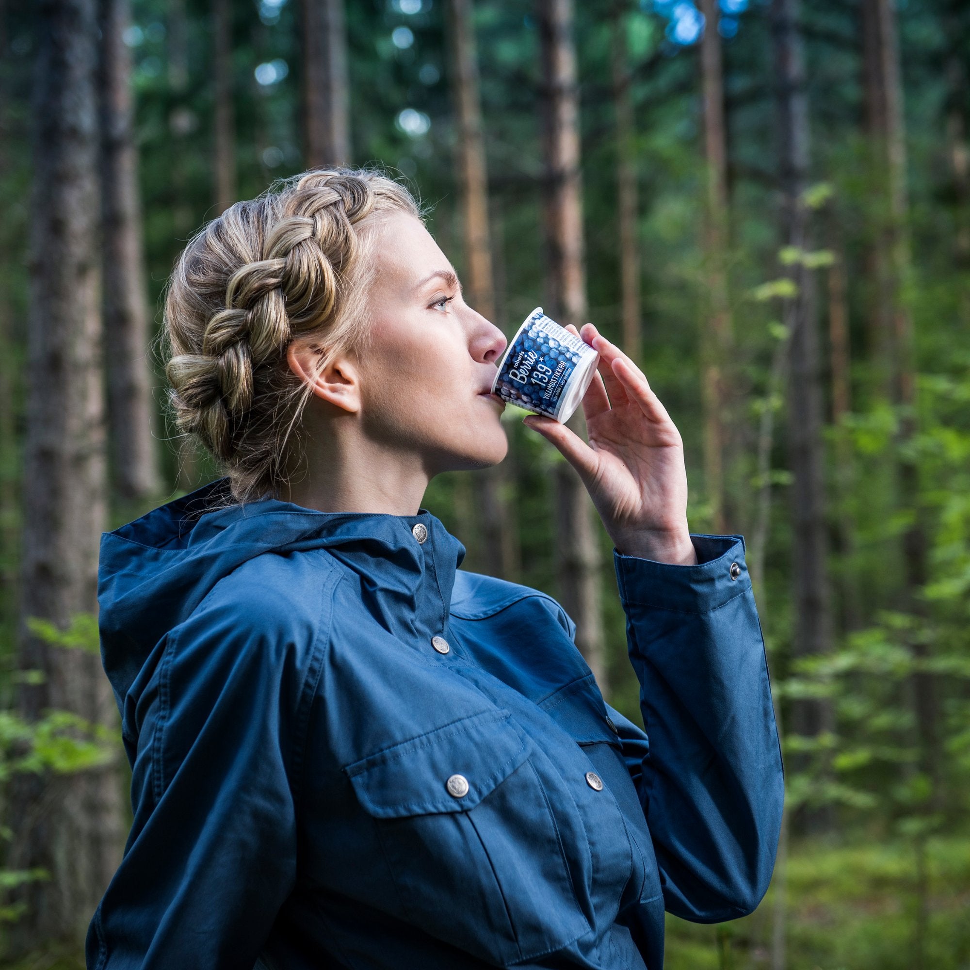 Woman drinking Roberts Berrie in the forest